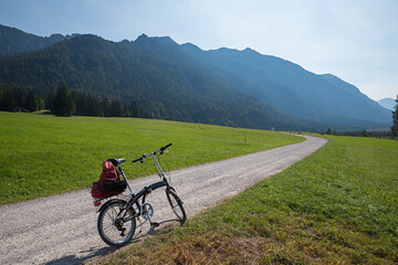 Fototapeta na wymiar bike tour in alpine landscape with a folding bicycle, upper bavaria