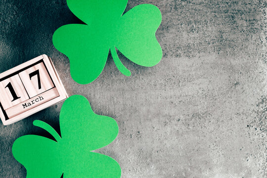 St. Patricks day, lucky charms. wooden date block calendar for St Patrick's Day, March 17 on dark gray background. Flat lay, top view, copy space