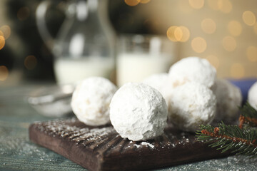 Fototapeta na wymiar Tasty Christmas snowball cookies on table, closeup. Space for text