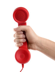 Woman holding red corded telephone handset on white background, closeup. Hotline concept