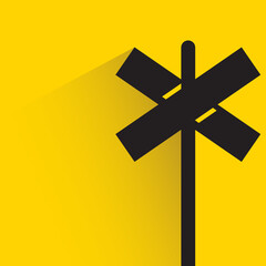 cross signage road sign with shadow on yellow background