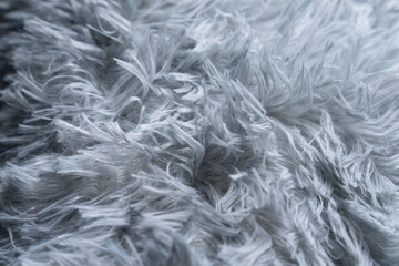 Close up white shaggy artificial fur texture or carpet for background.