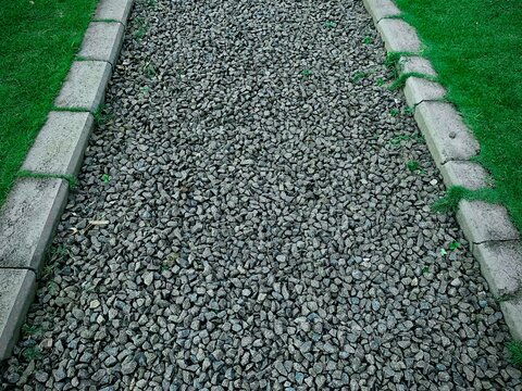 Gravel road in the middle of green grass