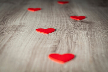 Red hearts on wooden backround.