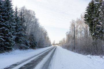 in the winter cold sunset black asphalt looks frozen