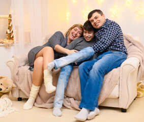 portrait of a family sitting on a sofa at home