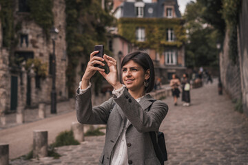 Fototapeta premium Young urban business woman talking on phone on city street 