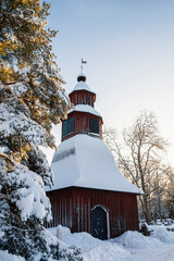 Wooden bell tower of The Sammatti Church in winter, Lohja, Finland