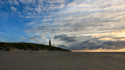 Fototapeta na wymiar Sunset at Texel beach with light house