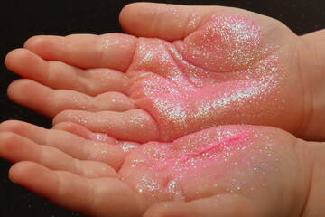 pink sequins on children's hands