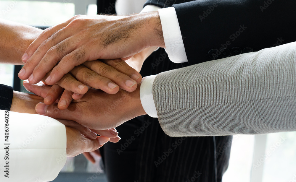 Wall mural close up picture of hands of multiethnic business team touching in circle for sign of unity and inte