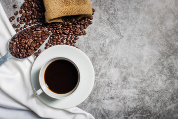 Background Coffee cup and beans on old kitchen table. Top view with copyspace for your text