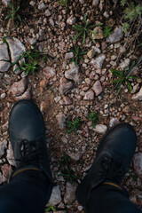 Close-up of a man's black boots while walking in the mountains in Palma de Mallorca