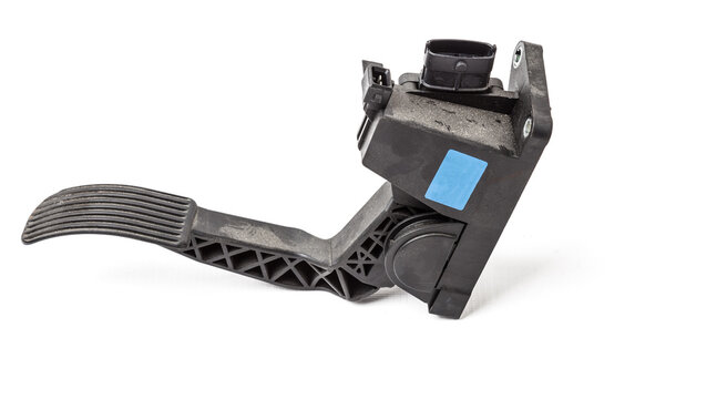 Gas pedal on a white isolated background in a photo studio for sale in a car service. Black auto part for replacement during repair in the workshop. Spare part junkyard.