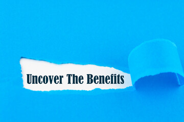 Uncover The Benefits text on blue envelope. Word Uncover The Benefits on torn paper. Concept Image.