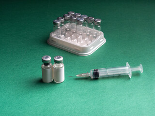 Glass vials in which the liquid with the vaccine is in the row in the tray