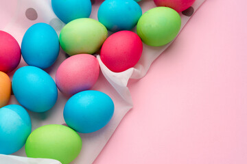 Painted Easter eggs on pink background top view