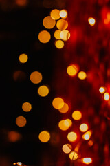 Blurred Christmas lights with bokeh effect Background. Abstract defocused colorful lights. Golden glittering Xmas lights.Circular reflections of Christmas lights. Luxury glowing holiday scene