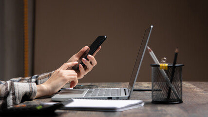 Cropped image of professional businesswoman working at her office via laptop, young female manager using portable computer device while sitting at modern loft, flare light, work process concept