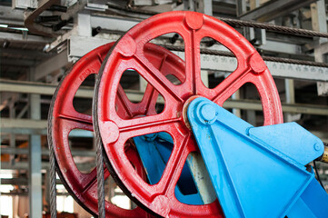 Large metal reel with stretched metal rope, part of a lift