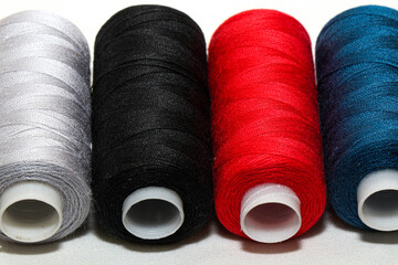 Colored threads and needles. Everything you need for sewing. Several spools of thread. Sharp...