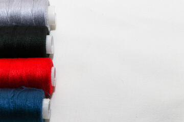 Colored threads and needles. Everything you need for sewing. Several spools of thread. Sharp...