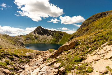 Fanealm und Wilder See in Suedtirol, Italy, Almlandschaft mit grünen Wiesen und blauem Himmel Schäfchenwolken, im Sommer, Alpine pastures with green meadows blue skies and fleecy clouds, in summer
