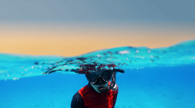 Diver woman in the deep sea, under water. Portrait of diver 
