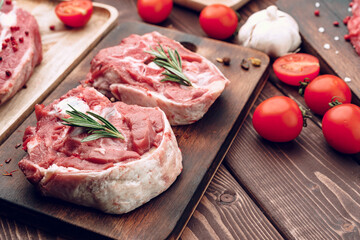 Raw meat beef shank slices on brown wooden board