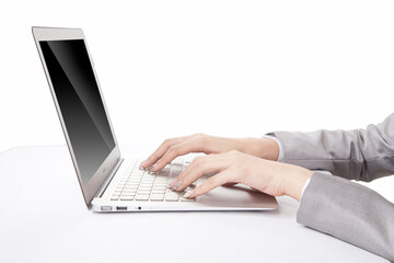 Portrait of young businesswoman using laptop,side view,close-up