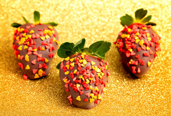 Chocolate Covered Strawberries with Sprinkles on a Golden Glittery Background