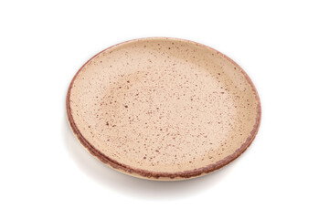Empty beige dotted ceramic plate isolated on white background. Side view, close up.