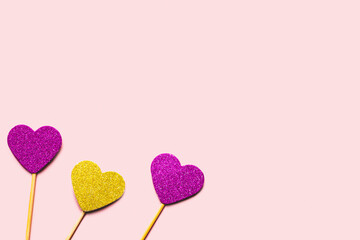 Hearts on a stick of purple and gold colors. Valentine's day concept.