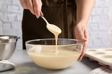 Woman making batter at light table, closeup