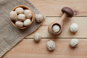 Tasty wallnuts mix on a wooden table and nutcracker