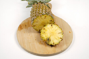 Whole pineapple with a few slices isolated on a bright background. Close-up of juicy and delicious fresh pineapples. Fresh fruit wallpaper concept for template design and mockup. fruits background.