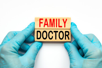 The doctor's hands show the word FAMILY DOCTOR . a gloved hand on a white background. Medical concept. the medicine