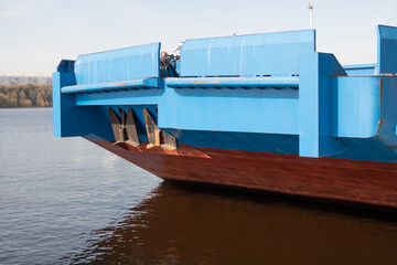 The bow of a cargo barge on a navigable river, blue top and red bottom, 2020, Moscow