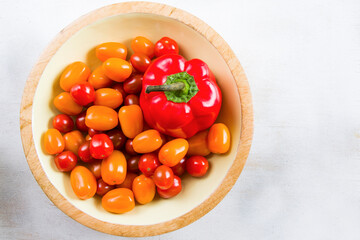 Cherry tomatoes and red bell pepper on the white background