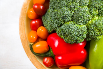 Cherry tomatoes, red bell pepper and broccoli on the white background