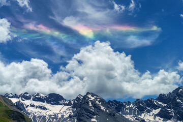 Iridescent cloud over the road to Stelvio pass (Lombardy) at summer