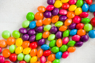 Obraz premium Skittles candy on the table, colorful sweet candy background