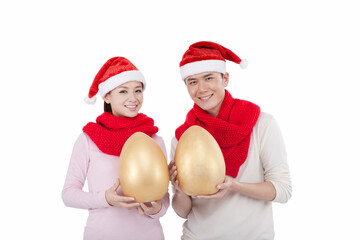 Portrait of young couple wearing Santa hats,holding Jin Dans