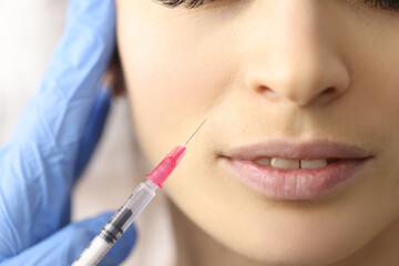 Beautician gives woman an injection in face