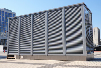 Commercial, industrial building HVAC system or heating, ventilating air conditioning system with an outdoor cooling unit, air cooled chiller, outdoor package HVAC unit.