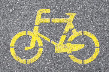 Bicycle path sign with yellow paint on the asphalt.