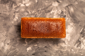 Composition with a bread on a textured plastered surface
