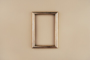 Gold text frame on a beige background. Copy space for text.