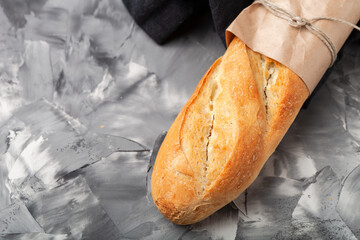 Composition with a bread on a textured plastered surface