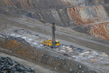 Working mining drilling machine in gold ore quarry pit